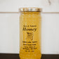12 oz. honey in a glass jar on a dark surface with a white background. Honey sold by Nystrom Orchard in Worthington Minnesota.