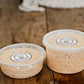 Both sizes of maple bacon cheese dip on a wooden surface. Made in the kitchen of Nystrom Orchard in Worthington Minnesota.