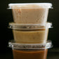 3 - 2 oz containers of house made dips stacked on top of each other on a black surface. Made in the kitchen of Nystrom Orchard in Worthington Minnesota. 