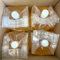 4 nip and grip plastic bags full of apple cider vinegar in a box. Made in the kitchen of Nystrom Orchard in Worthington Minnesota.