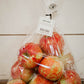 5 lb. Clear plastic bag of honeycrisp apples on a wooden surface with a white background. Picked in Nystrom Orchard in Worthington Minnesota.