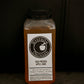 8 oz bottle of cold pressed cider with a dark background. Pressed in the kitchen of Nystrom Orchard in Worthington Minnesota.