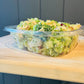 8 oz clear plastic container of broccoli salad with chicken. Made in the kitchen of Nystrom Orchard in Worthington Minnesota.