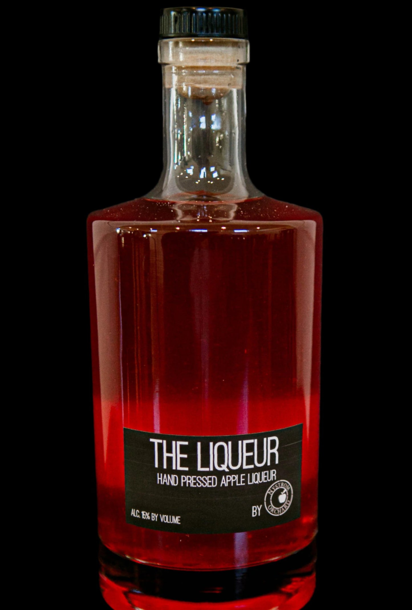 Bottle of apple liqueur on a black background. Made in the kitchen in Nystrom Orchard in Worthington Minnesota. 