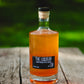 Apple Liqueur on a wooden table in the orchard. Made in the kitchen of Nystrom Orchard in Worthington Minnesota.