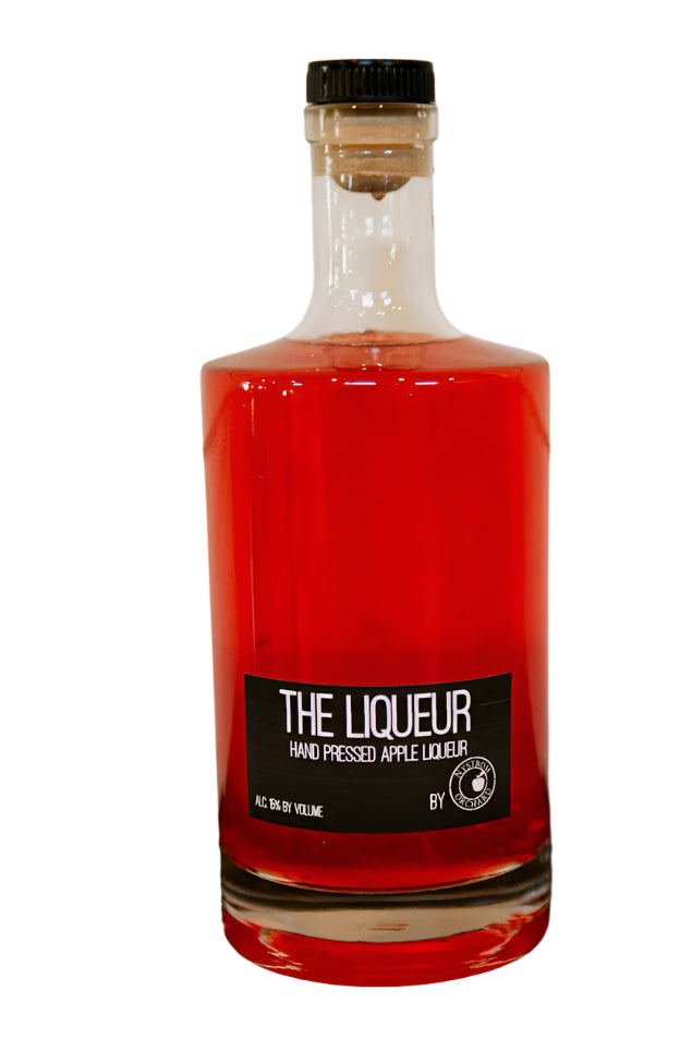 Hand pressed apple liqueur in a glass bottle on a white background. Made in the kitchen of Nystrom Orchard in Worthington Minnesota.