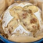 Loaf of rustic sourdough bread in a blue dutch oven. Baked in the kitchen of Nystrom Orchard in Worthington Minnesota. 