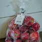 Plastic 5lb bag of gala apples on a concrete surface with a white background. Picked at Nystrom Orchard in Worthington Minnesota.