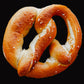Single pretzel on a black background. Baked by the kitchen at Nystrom Orchard in Worthington Minnesota.