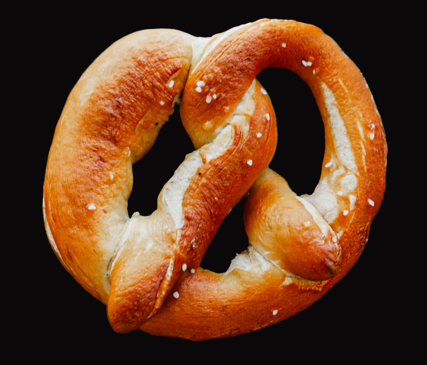 Single pretzel on a black background. Baked by the kitchen at Nystrom Orchard in Worthington Minnesota.