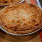 Apple pie baked in a metal pie dish on a metal tray. Baked in the kitchen at Nystrom Orchard in Worthington Minnesota.
