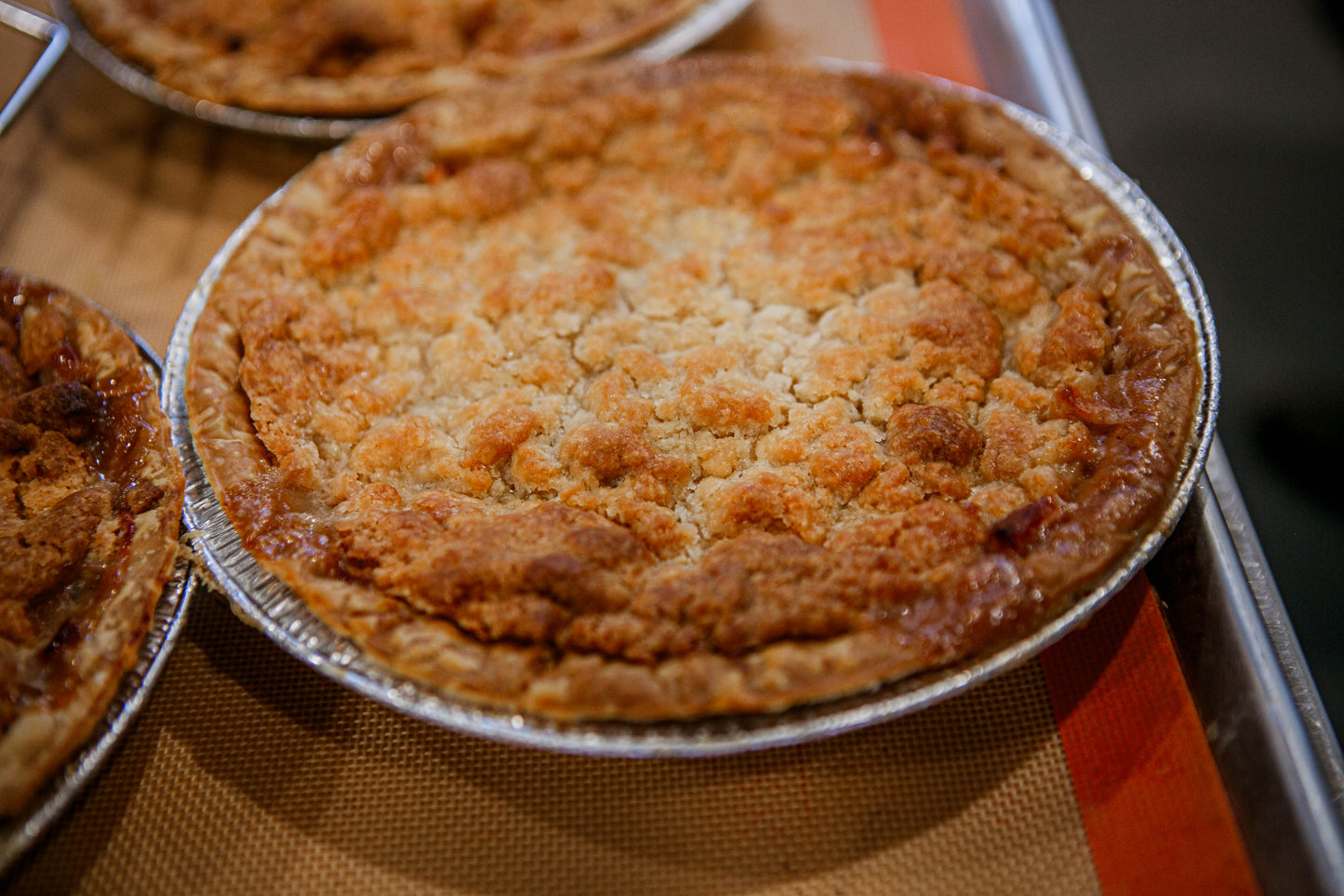 Apple pie baked in a metal pie dish on a metal tray. Baked in the kitchen at Nystrom Orchard in Worthington Minnesota.