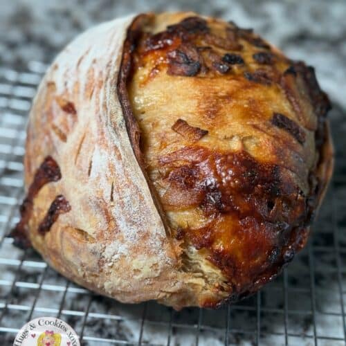 Caramelized onion and gouda rustic loaf of sourdough bread on a cooling rack. Baked in the kitchen of Nystrom Orchard in Worthington Minnesota.