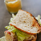 Sourdough Sandwich with chicken salad and lettuce with a honey mustard dipping sauce in the background. Made in the kitchen of Nystrom Orchard in Worthington Minnesota.