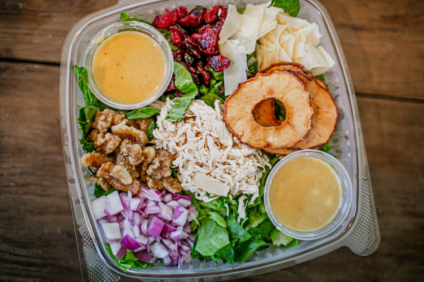 Salad with cranberries, walnuts, red onions, apples, parmesan cheese and honey mustard dressing. Made in the kitchen of Nystrom Orchard in Worthington Minnesota.