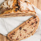 Rustic loaf of sourdough bread on a white cloth on a wooden cutting board. Baked in the kitchen of Nystrom Orchard in Worthington Minnesota.  