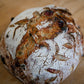 Cranberry cream cheese loaf of sourdough bread on a wooden cutting board. Baked in the kitchen of Nystrom Orchard in Worthington Minnesota.