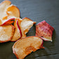 Dried apple chips on a wooden surface. Dried in the kitchen of Nystrom Orchard in Worthington Minnesota.