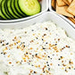 Dip with sour cream, cream cheese, and everything bagel seasoning, with cucumbers and crackers beside.  Made in the kitchen at Nystrom Orchard in Worthington Minnesota.