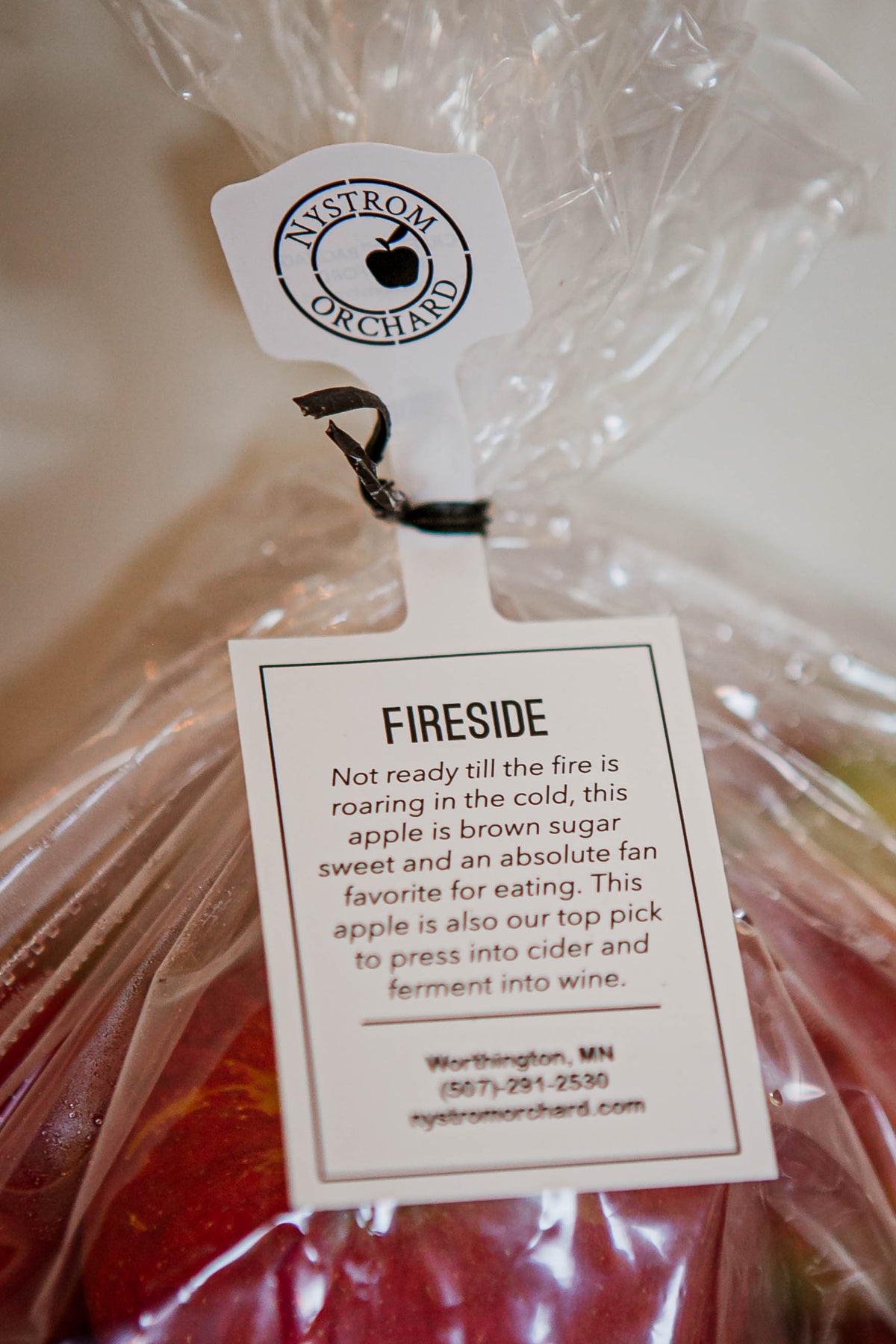 Fireside apple tag on a bag of appes with a white background. Picked in Nystrom Orchard in Worthington Minnesota.