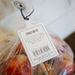 Label for frostbite apples with apples in a bag with a white background. Picked in Nystrom Orchard in Worthington Minnesota.