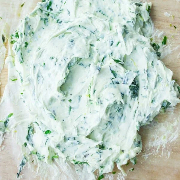 Cream cheese and herbs spread on a wooden surface. Prepared in the kitchen at Nystrom Orchard in Worthington Minnesota. 