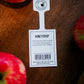 Honeycrisp tag with honeycrisp apples on a wooden surface. Picked at Nystrom Orchard in Worthington Minnesota.