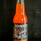 Glass bottle of Jones Orange cream flavored soda on a dark background. Sold in the store of Nystrom Orchard in Worthington Minnesota.