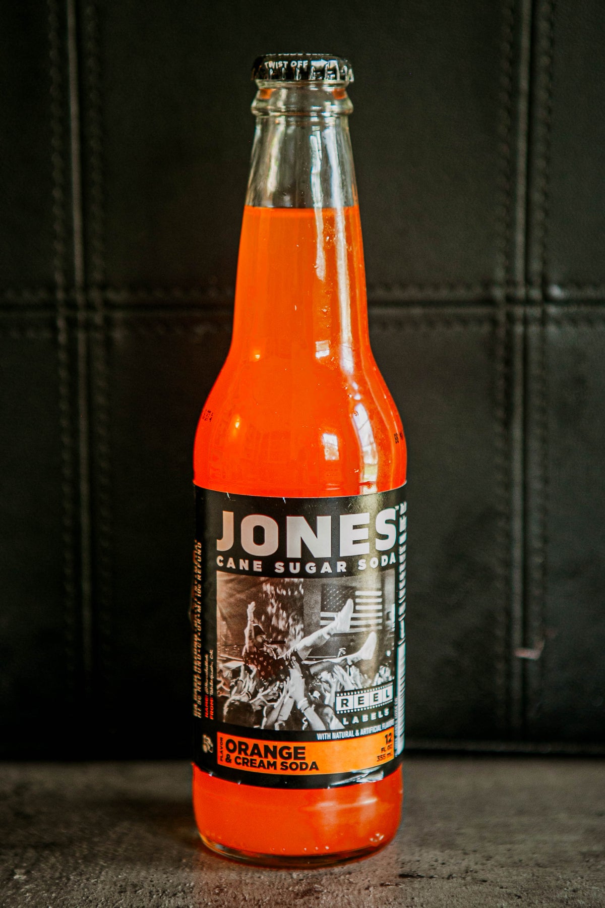 Glass bottle of Jones Orange cream flavored soda on a dark background. Sold in the store of Nystrom Orchard in Worthington Minnesota.