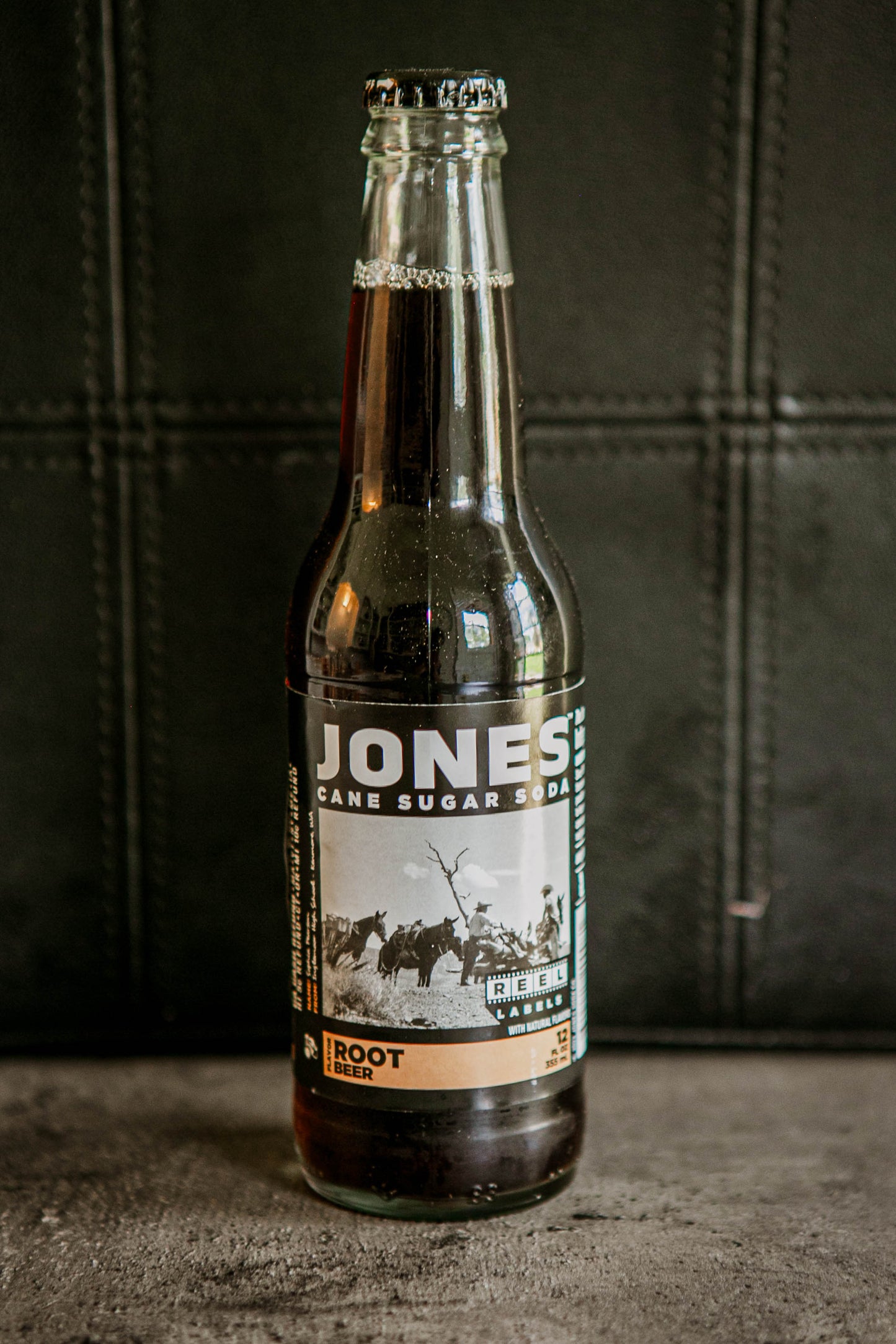 Glass bottle of Jones root beer soda on a dark background. Sold in the store of Nystrom Orchard in Worthington Minnesota.