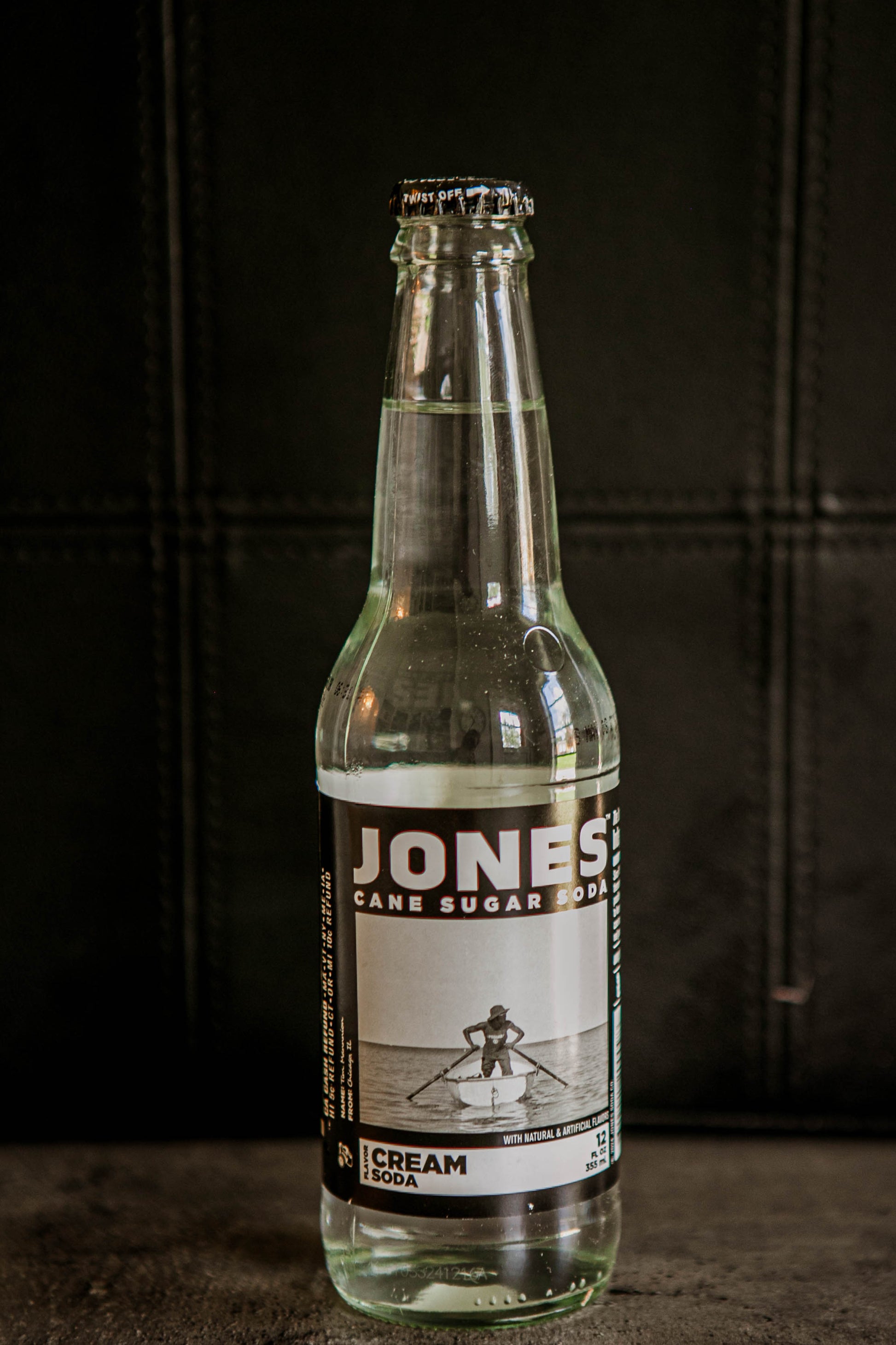 Glass bottle of Jones Cream flavored soda on a dark background. Sold in the store of Nystrom Orchard in Worthington Minnesota.