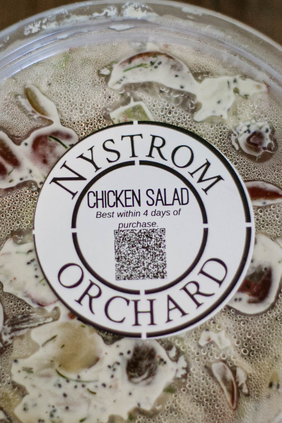 Nystrom Orchard chicken salad container with a close up of the label. Made in the kitchen of Nystrom Orchard in Worthington Minnesota.