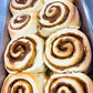 Pan of baked sourdough cinnamon rolls without frosting. on a metal table. Baked in the kitchen of Nystrom Orchard in Worthington Minnesota.