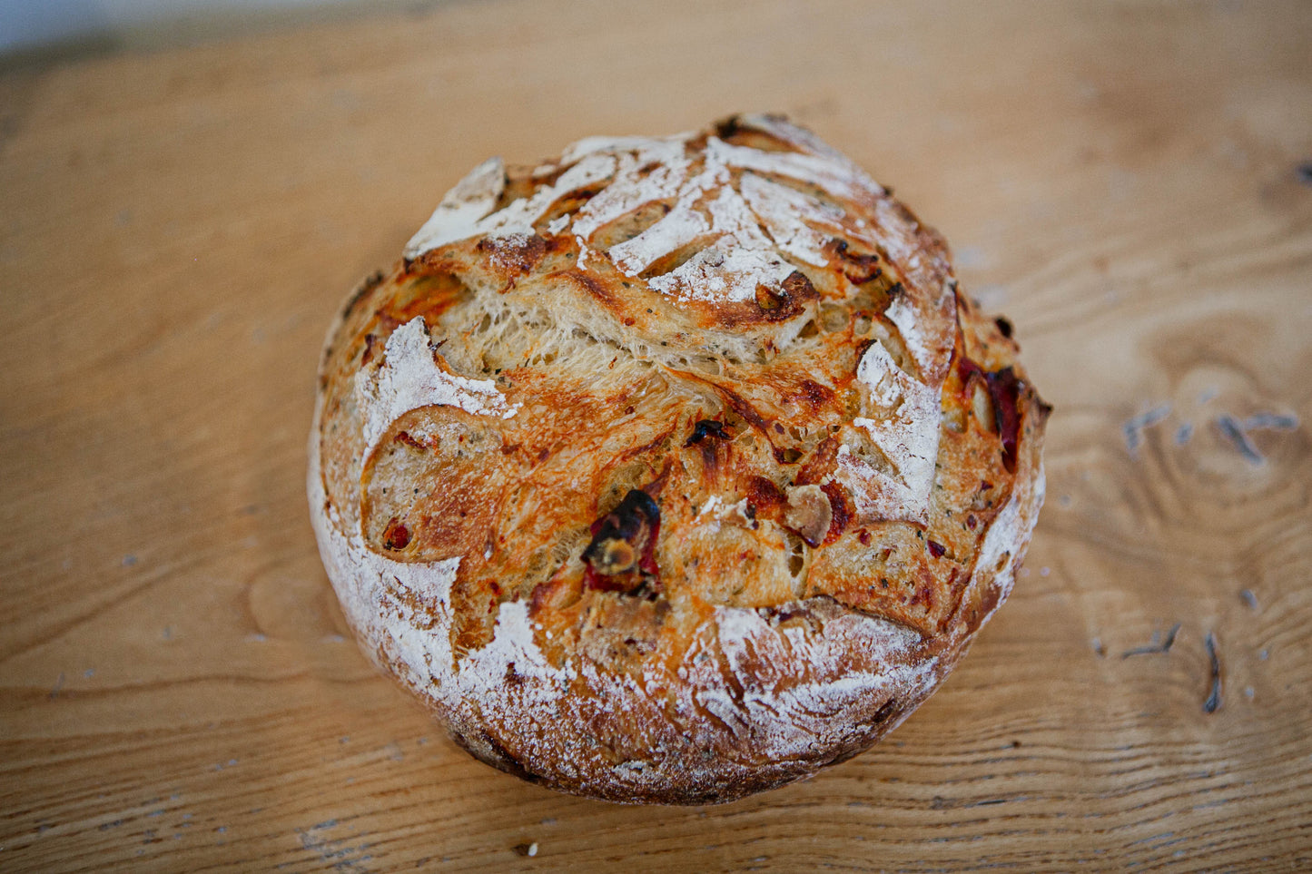 Artisan loaf of pepperoni and cheese sourdough bread on a wooden surface. Baked in the kitchen at Nystrom Orchard in Worthington Minnesota. 