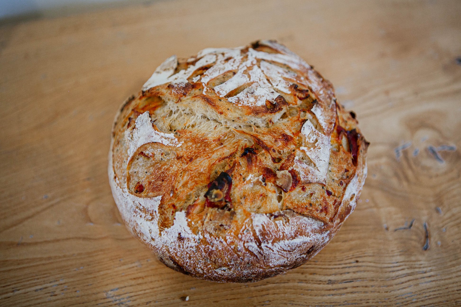 Artisan loaf of pepperoni and cheese sourdough bread on a wooden surface. Baked in the kitchen at Nystrom Orchard in Worthington Minnesota. 