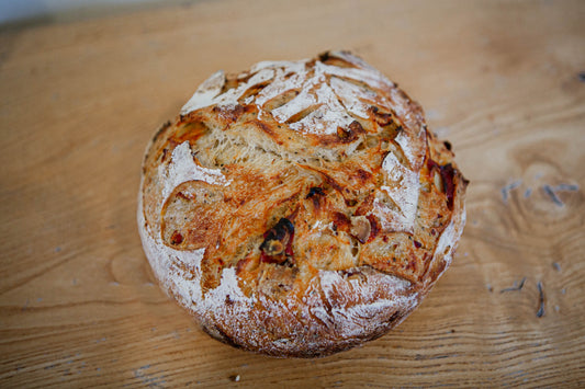 Artisan loaf of pepperoni and cheese sourdough bread on a wooden surface. Baked in the kitchen at Nystrom Orchard in Worthington Minnesota. 