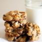 Stack of salted orchard smore cookies with a glass of milk on a white surface.  Baked in the kitchen of Nystrom Orchard in Worthington Minnesota.