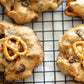 Cookies with marshmallows pretzels and chocolate chips on a cooling rack.  Baked in the kitchen of Nystrom Orchard in Worthington Minnesota.