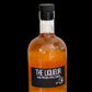 Hand pressed apple liqueur in a glass bottle on a black background. Made in the kitchen of Nystrom Orchard in Worthington Minnesota.  