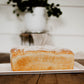 Loaf of sourdough sandwich bread on a white plate with a blurred background. Baked in the kitchen at Nystrom Orchard in Worthington Minnesota.
