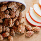 Spiced nuts with apple slices on a wooden surface. Baked in the kitchen of Nystrom Orchard in Worthington Minnesota.
