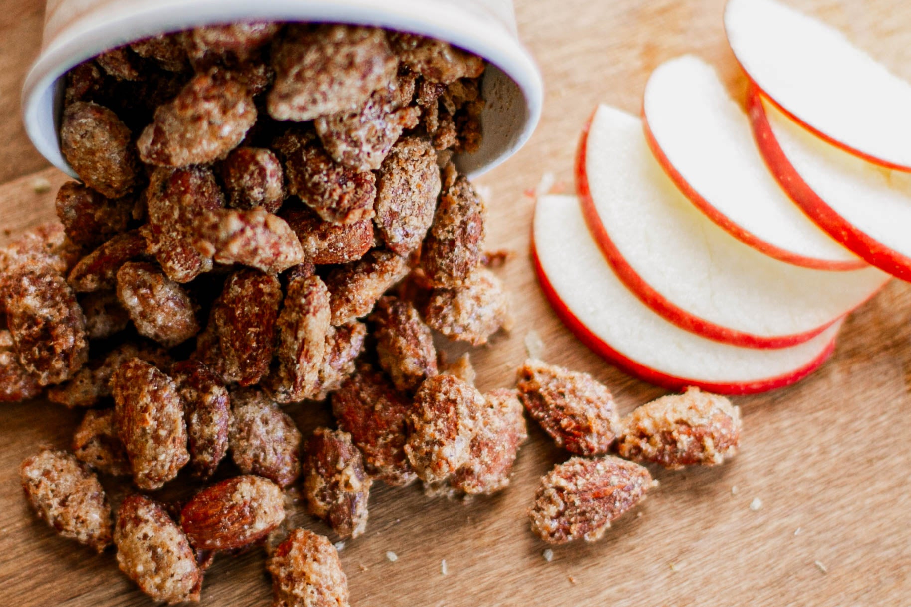 Spiced nuts with apple slices on a wooden surface. Baked in the kitchen of Nystrom Orchard in Worthington Minnesota.