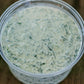 Container of creamy spinach dip on a wooden surface. Mixed in the kitchen of Nystrom Orchard in Worthington Minnesota.