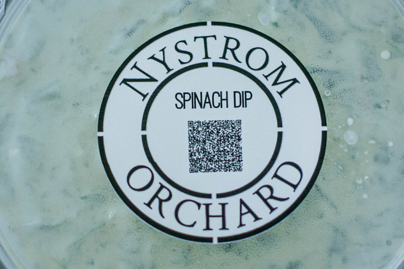 Close up of Nystrom Orchard Spinach Dip container with label. Made in the kitchen of Nystrom Orchard in Worthington Minnesota.