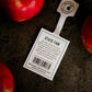 State fair apple tag with red apples beside on a black surface. Picked in Nystrom Orchard in Worthington Minnesota.