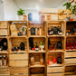 Apple crates stacked to make a wall and shelves with Nystrom Orchard store products and plants. In the store of Nystrom Orchard in Worthington Minnesota.