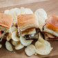3 sliders with different fillings on a wooden board with potato chips. Made in the kitchen of Nystrom Orchard in Worthington Minnesota.