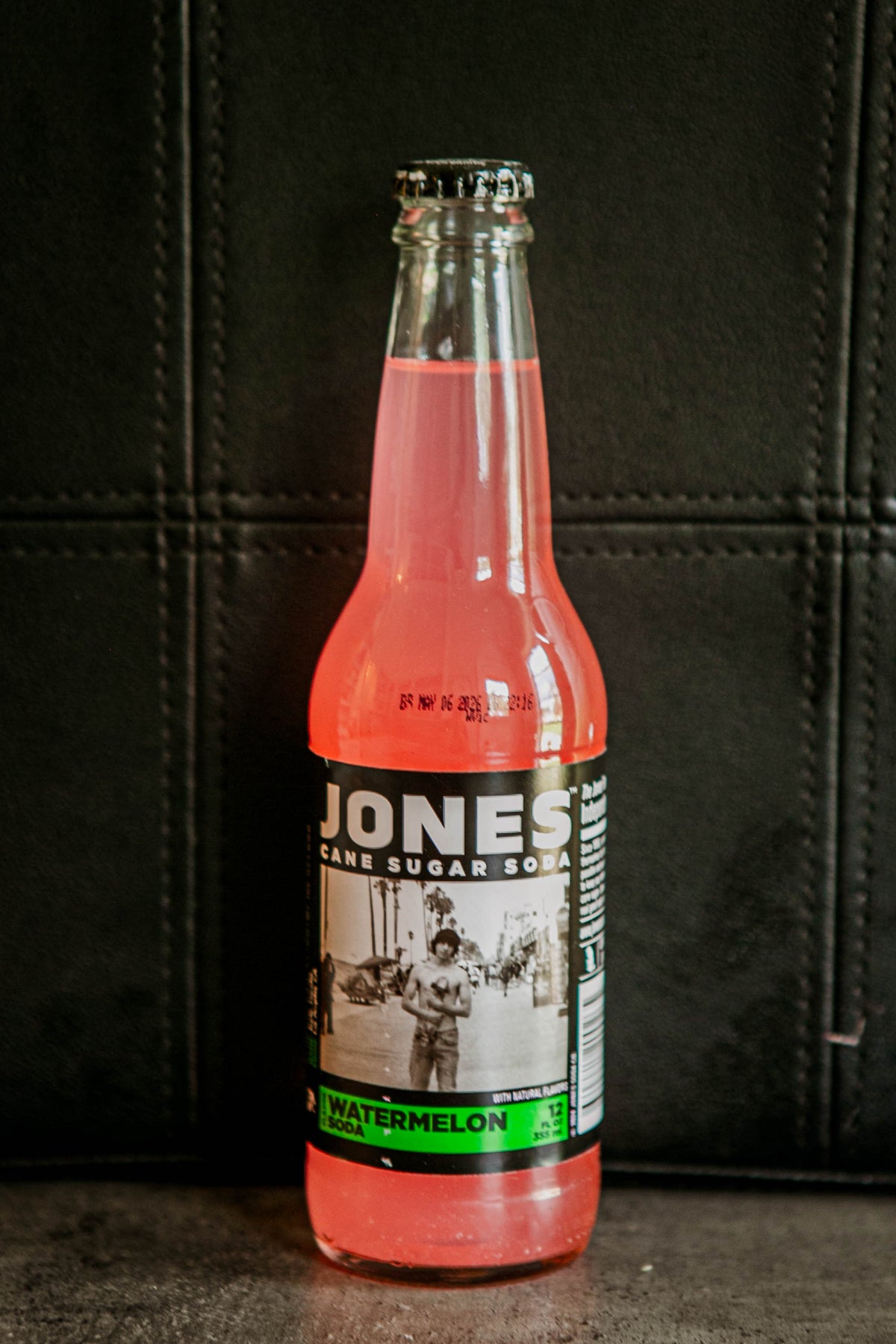 Glass bottle of Jones watermelon flavored soda on a dark background. Sold in the store of Nystrom Orchard in Worthington Minnesota.