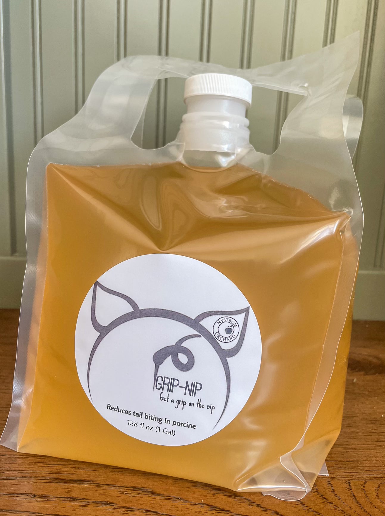 Plastic bag of apple cider vinegar with a label for animals. Made in the kitchen of Nystrom Orchard in Worthington Minnesota.