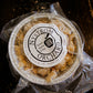 Frozen dutch apple crisp in a foil pan on  a dark surface. Made in the kitchen at Nystrom Orchard in Worthington Minnesota.